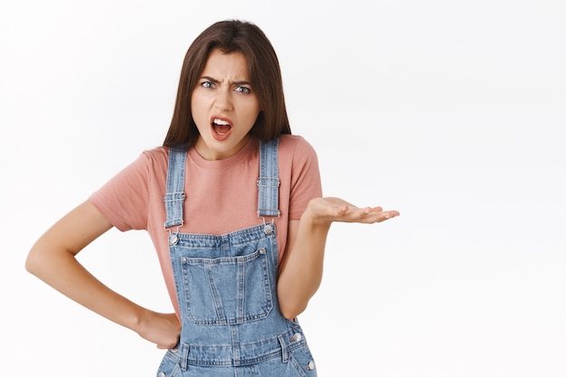 Pissed, angry complaining woman staring outraged, raise on hand in dismay or scorn, arguing, having fight with coworker, swearing or cursing bothered, standing annoyed white background