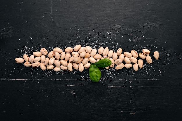 Pistachenoten op een donkere houten ondergrond Gezonde snacks Bovenaanzicht Vrije ruimte voor tekst