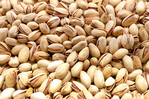 Pistachetextuur en achtergrond Smakelijke pistachenoten als achtergrond als pistachetextuur