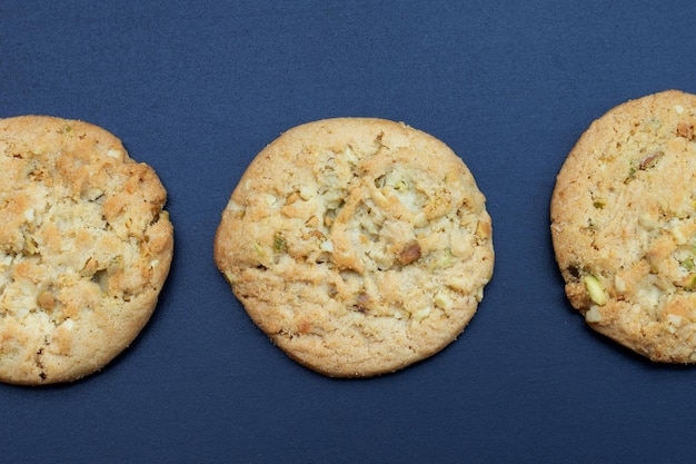 Pistachio and almond cookies on dark background