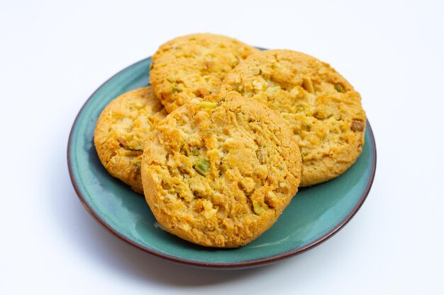 Pistachio and almond cookies on white background