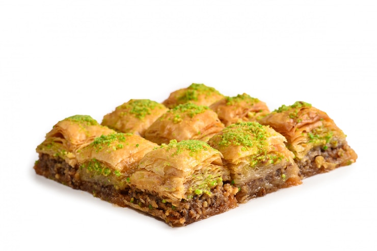 Photo pistachio baklava on a white isolated. dessert.