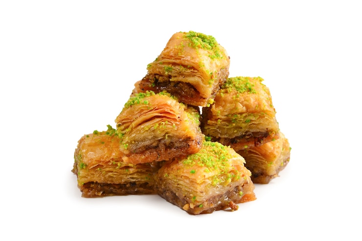 Photo pistachio baklava on a white wall. dessert.