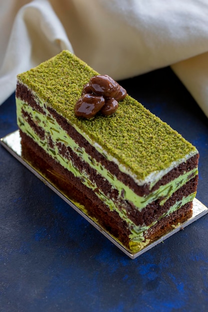 Pistachio and cream cake on a blue background