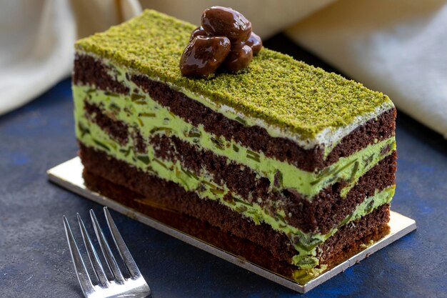 Pistachio and cream cake on a blue background