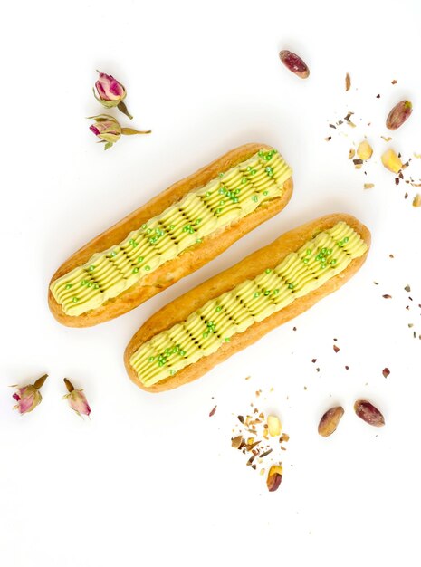 Pistachio eclairs on white background.