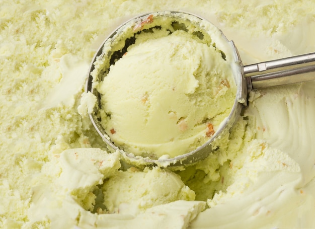 Pistachio ice cream forged from a container with dishes