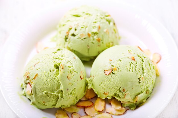 Pistachio ice cream scoops on a plate