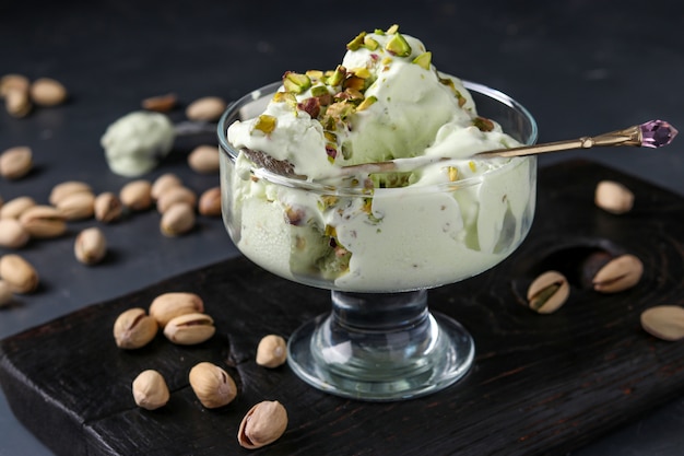 Pistachio ice cream with pistachio nuts glass ice-cream bowl, horizontal photo