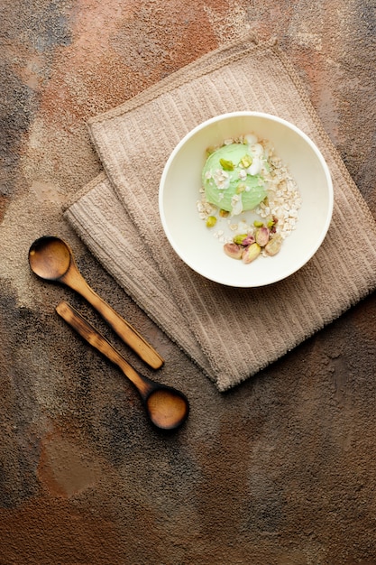 Pistachio ice cream with white chocolate on old wooden table. Healthy food. Vegan food