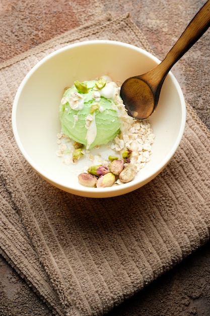 Pistachio ice cream with white chocolate on old wooden table. Healthy food. Vegan food