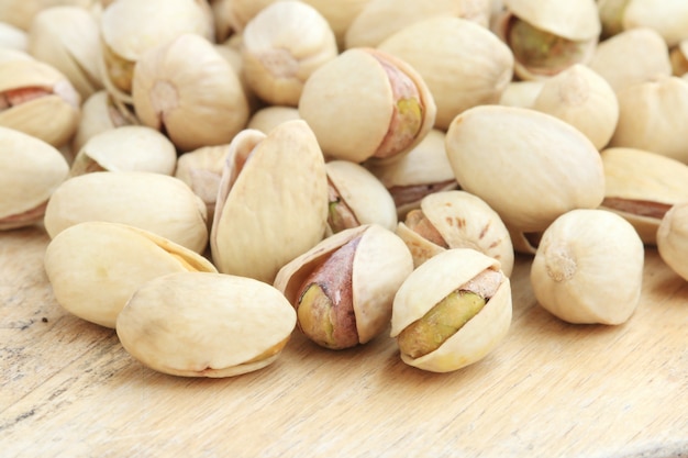 Pistachio nut on wood background.