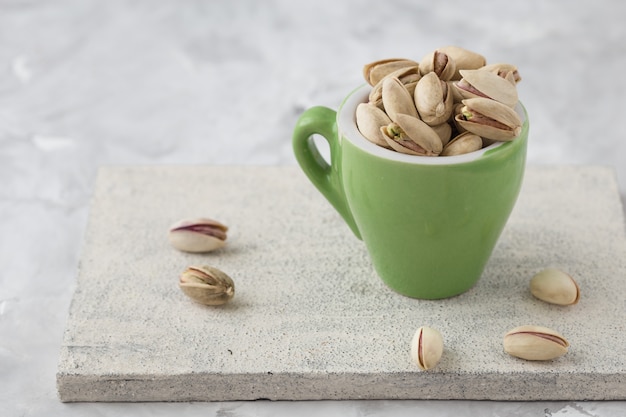 Pistachio nuts on concrete background. Roasted salted pistachios.