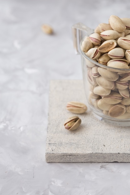 Pistachio nuts on concrete background. Roasted salted pistachios.