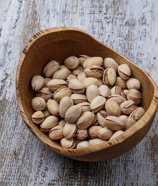 Pistachio nuts in wooden bowl