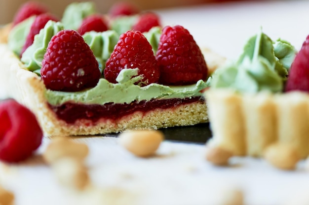 Pistachio tart Pistachio tart on white Belgian chocolate BARRY with a layer of raspberry confit crispy shortbread base fading cream and juicy raspberries A classic combination in miniature format