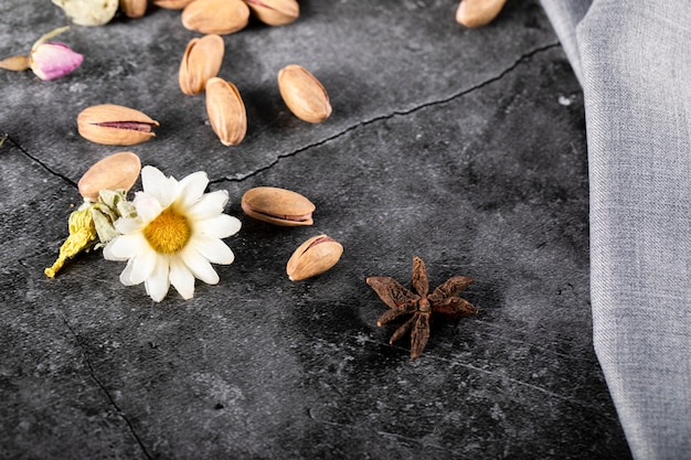 Pistachios and anise flower on a piece of marble