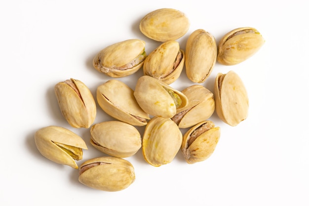 Pistachios isolated on white background, top view. Flat lay