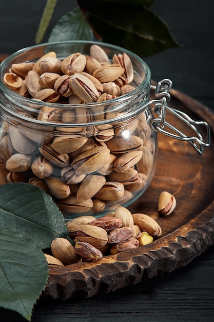 Pistachios nuts on dark table, top view, healthy snack