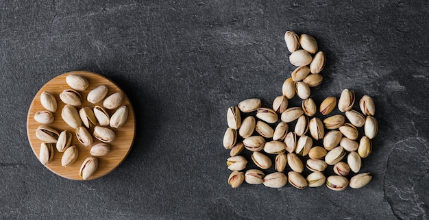 Pistachios nuts on wooden table Pistachio on wooden dark table