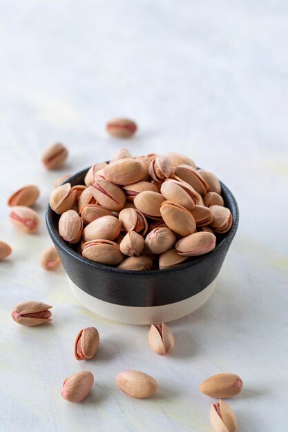 Pistachios on a white wooden background