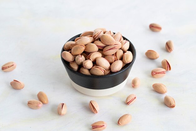 Pistachios on a white wooden background