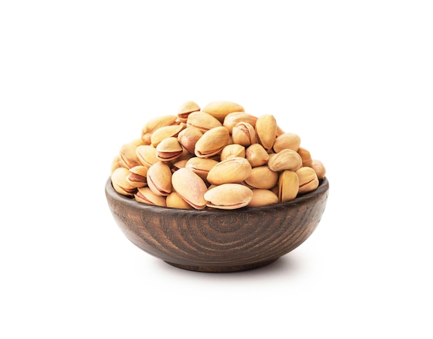 Pistachios with wooden bowl isolated on white