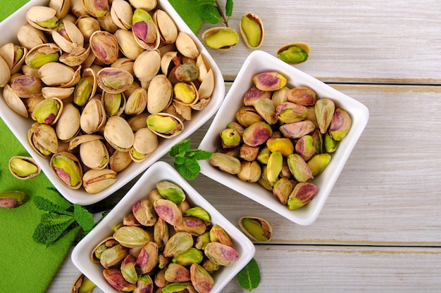 Pistachios on wooden background with green napkin