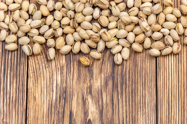 Pistachios on wooden background