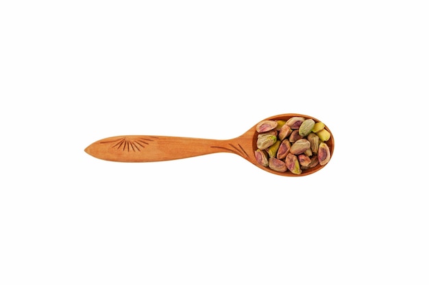 Pistachios in wooden spoon white background top view Design element Peeled Green pistachio