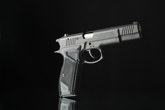 Pistol isolated on black. Self defense weapon