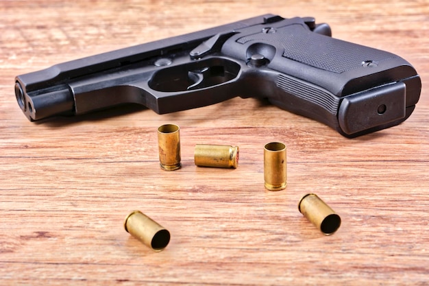 Pistol with empty cartridges on a table