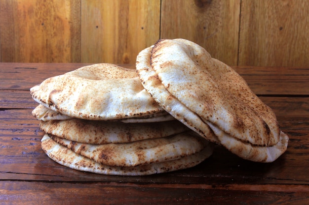 Pita bread isolated on rustic wooden table