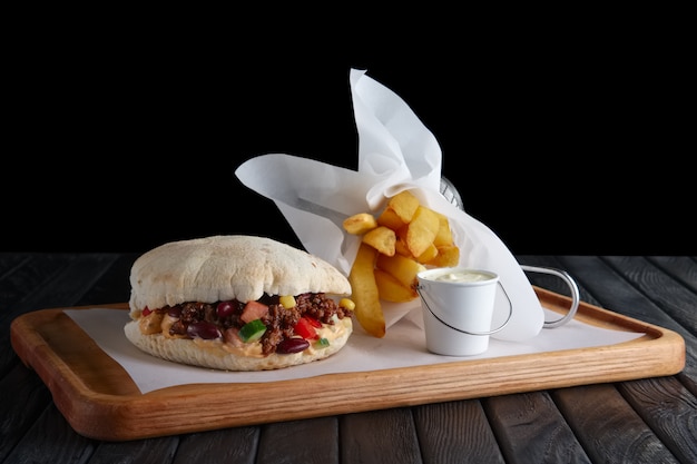 Pita bread with fried stuffing, beans and vegetables served with fried potato