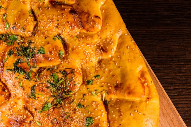 Pita bread with garlic on a wooden cutting board top view