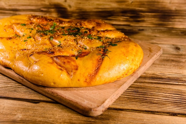 Pita bread with garlic on a wooden cutting board