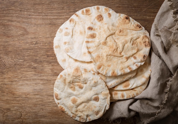 Pita bread on a wooden board top view