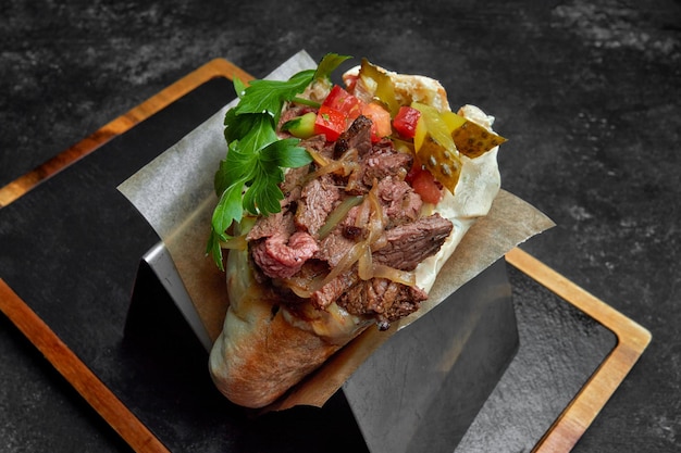 Pita with beef vegetables and parsley on a board