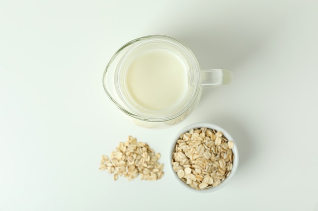 Pitcher of milk and cereals on white