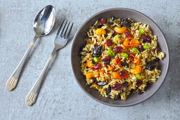 Pittige rijst met gedroogde vruchten. Veganistische kom met pikante rijst. Gezonde lunch