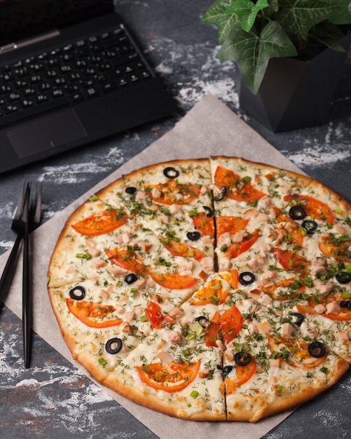 Pizza in the assortment. Pizza slices with meat, mushrooms, tomatoes and other vegetables. Italian pizza