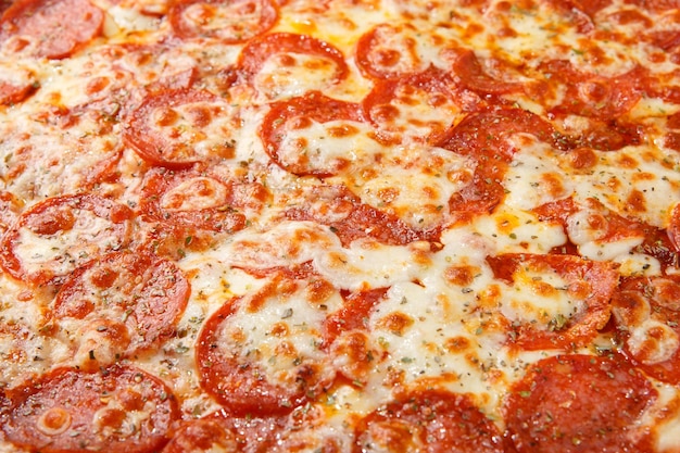 Pizza background macro shot of italian Pepperoni pizza