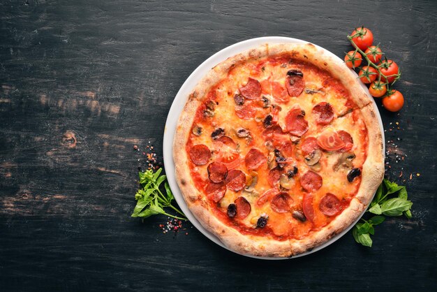 Pizza Bavaria Sausages mushrooms tomato paste Italian traditional dish On the old background Top view Free space for your text