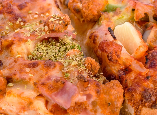 Pizza becon Oregano spice close-up