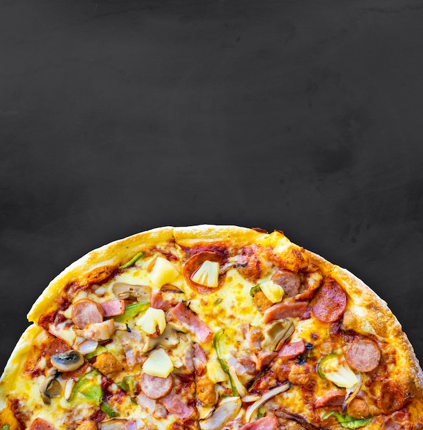 Pizza on the black chalkboard background top view