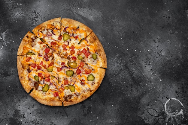 Pizza on black concrete wall. Top view with copy space.