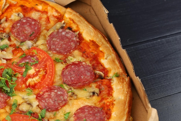 Pizza in box open Pizza in the in delivery box against a dark background