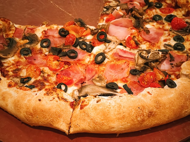 Pizza capriciosa with cheese stuffed crust in pizzeria food