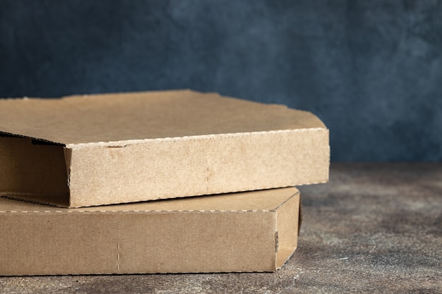 Pizza cardboard box on dark table