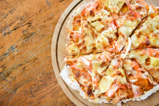 Pizza cheese slice on wooden tray